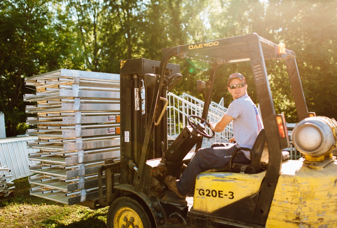 Rampit USA team member moves wheelchair ramps with a forklift at the manufacturing facility.