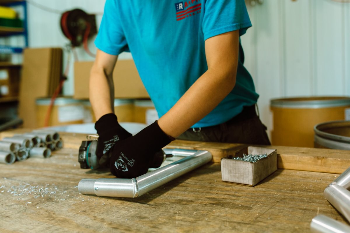 Rampit USA team member assembles wheelchair-accessible ramp components in the workshop.