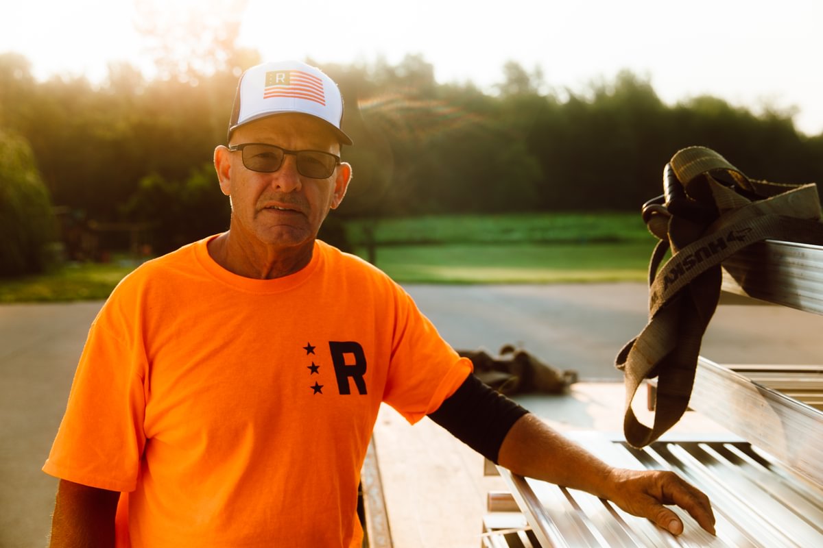Rampit USA installer prepares wheelchair-accessible ramp materials at a customer installation site.
